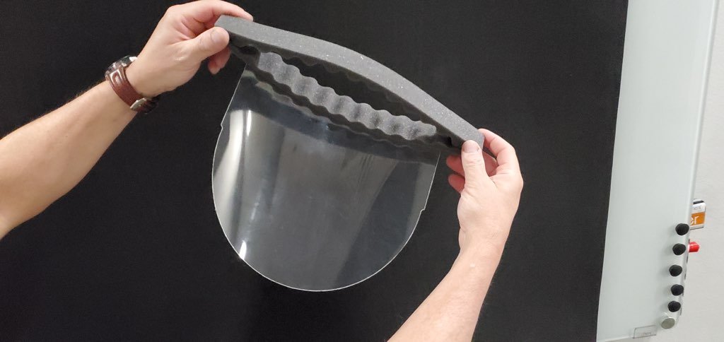 Hands holding a face shield protector